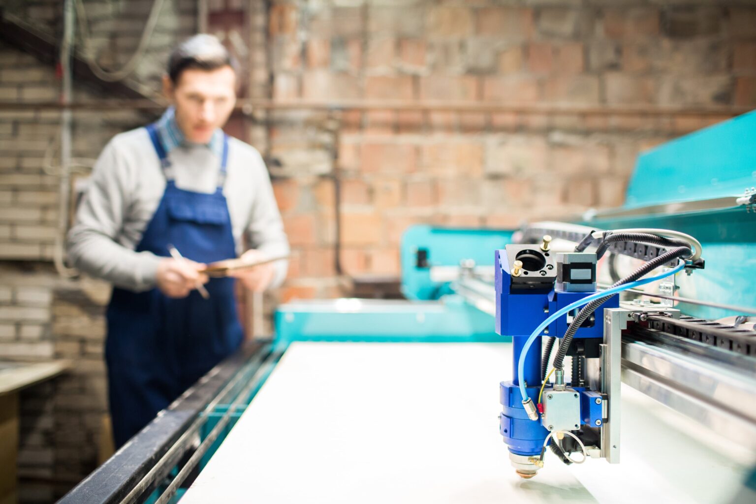 Man using a laser cutter as a 3D printer