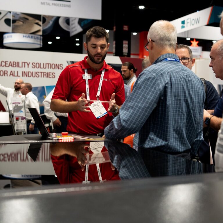 Photo of Boss employee discussing laser cutting safety with customer